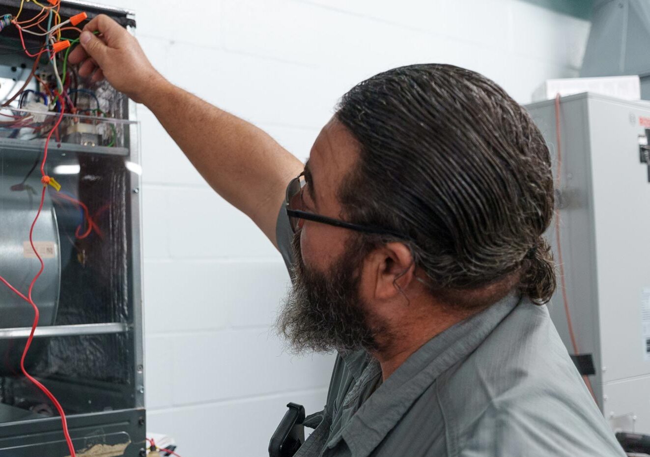A technician working on an oil furnace - Byrum Heating & AC A technician working on an oil furnace